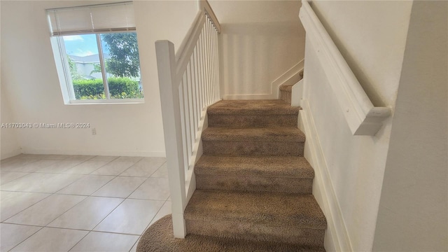 stairway featuring tile patterned floors