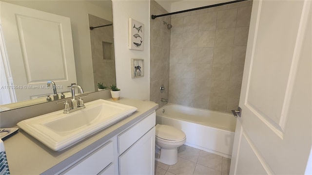 full bathroom with tile patterned floors, tiled shower / bath, vanity, and toilet