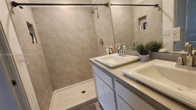 bathroom with vanity and tiled shower