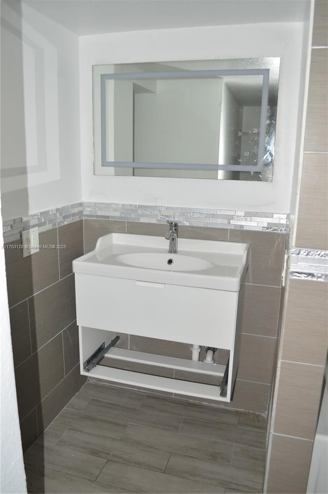 bathroom with tile walls and vanity