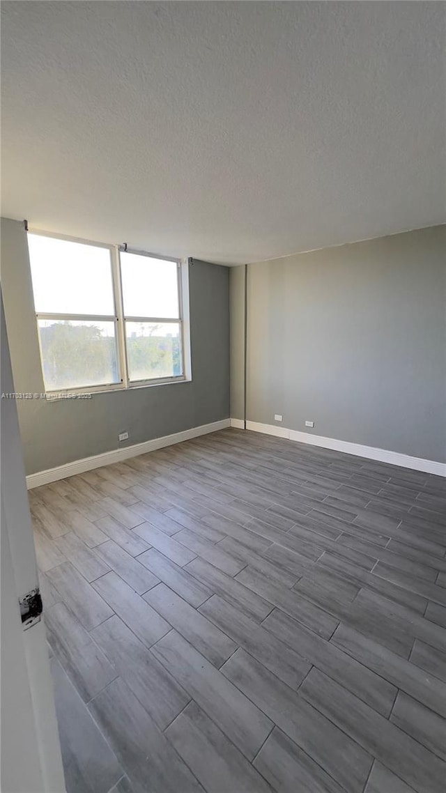 spare room with a textured ceiling