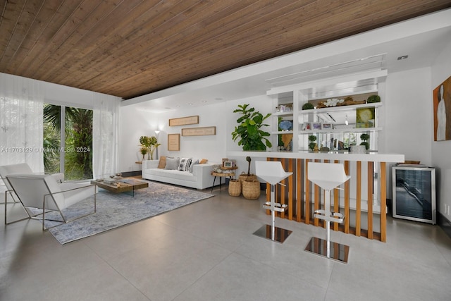 living room with wine cooler, concrete floors, and wooden ceiling