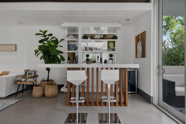 bar with concrete flooring and wine cooler