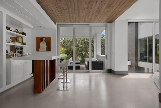 interior space featuring a wall of windows and wooden ceiling