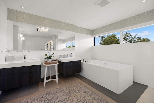 bathroom featuring vanity and a tub