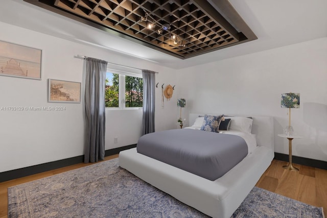 bedroom with wood-type flooring