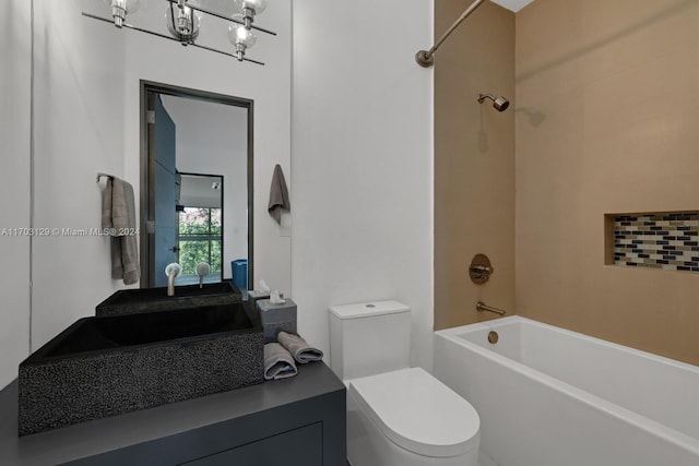 bathroom with bathtub / shower combination, toilet, and a notable chandelier