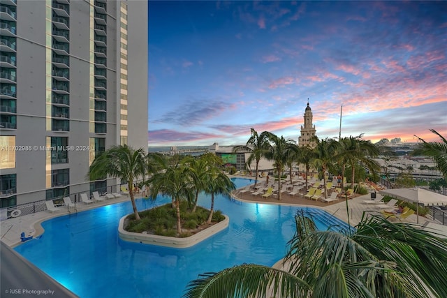 view of pool at dusk