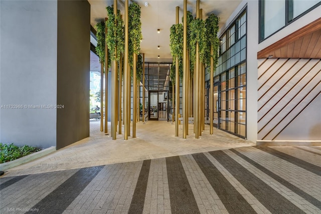 hallway with a towering ceiling and carpet