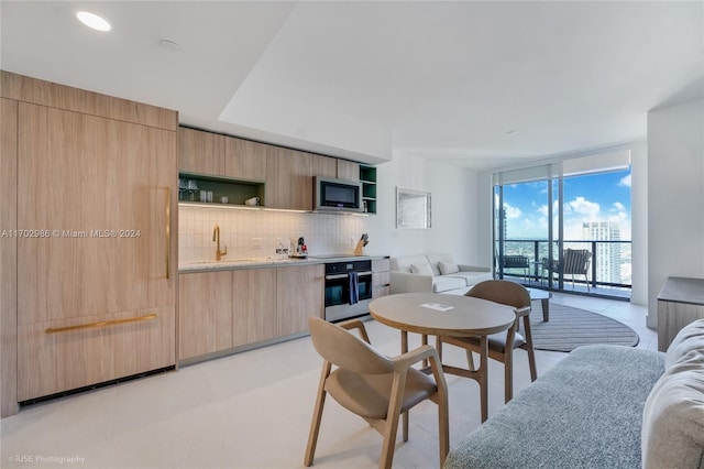 tiled dining space with a wall of windows and sink