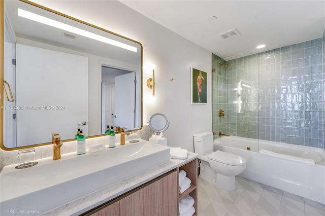 full bathroom featuring tiled shower / bath combo, toilet, and vanity