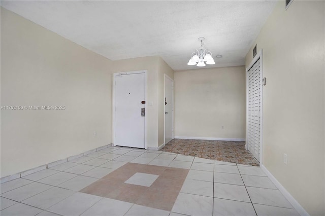 interior space featuring a chandelier and a textured ceiling