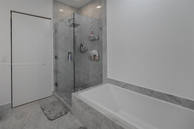 bathroom featuring separate shower and tub