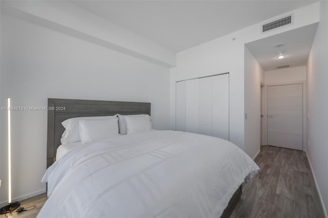 bedroom featuring a closet and dark wood-type flooring