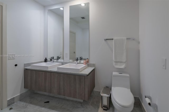 bathroom featuring vanity and toilet