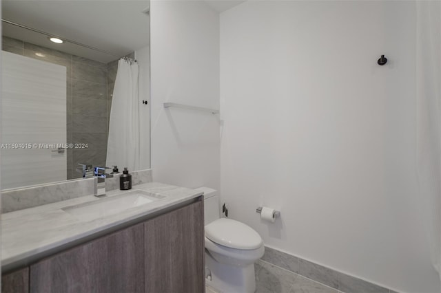 bathroom with tile patterned floors, vanity, toilet, and a shower with shower curtain