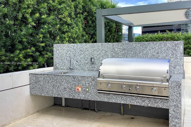 view of patio / terrace featuring grilling area and sink