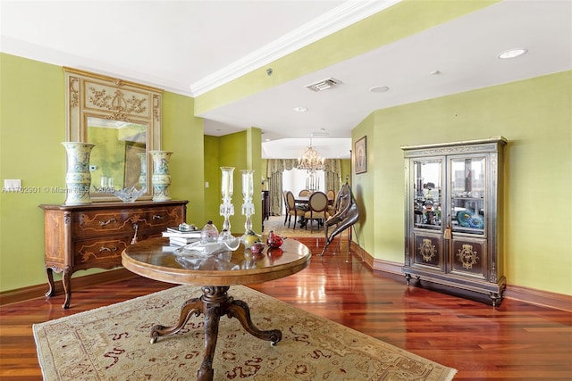 dining room with ornamental molding, visible vents, a chandelier, wood finished floors, and baseboards