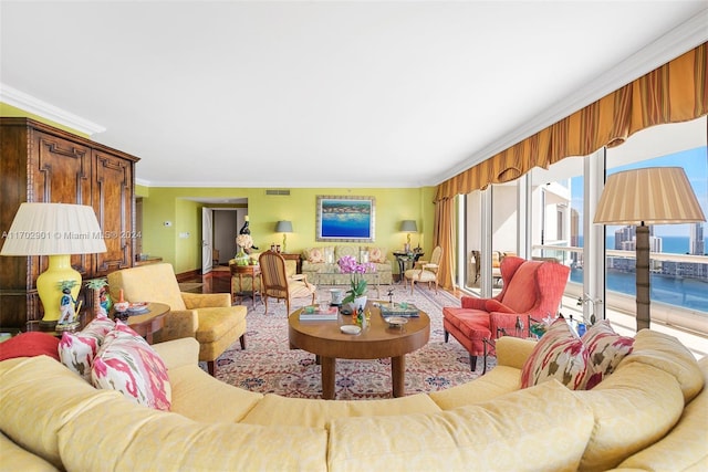 living room with a water view and crown molding