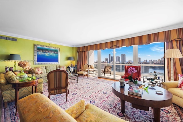 living room with a water view and ornamental molding