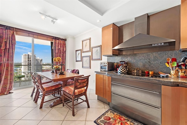 dining space featuring floor to ceiling windows, ornamental molding, rail lighting, a toaster, and light tile patterned flooring