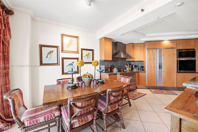 dining room featuring crown molding and light tile patterned flooring