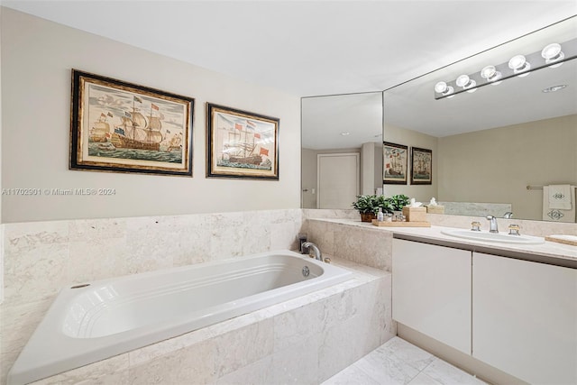 bathroom with vanity and a relaxing tiled tub