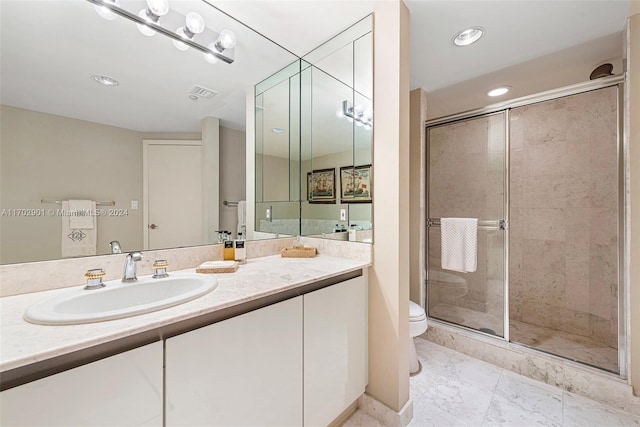 bathroom featuring vanity, toilet, and an enclosed shower