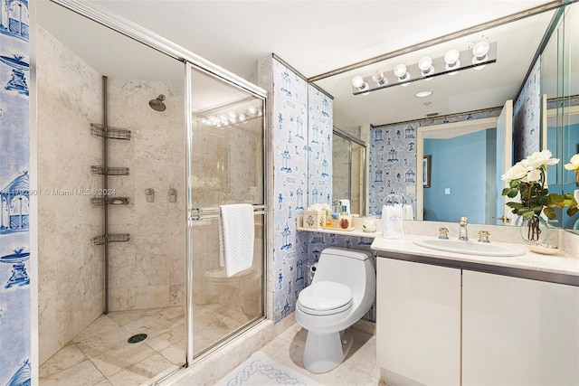 bathroom featuring tile patterned floors, vanity, a shower with shower door, and toilet