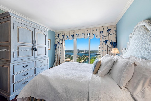 bedroom with access to exterior, a water view, and ornamental molding