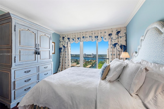 bedroom featuring a water view and crown molding