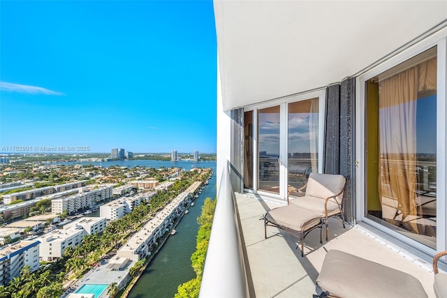 balcony featuring a water view and a view of city