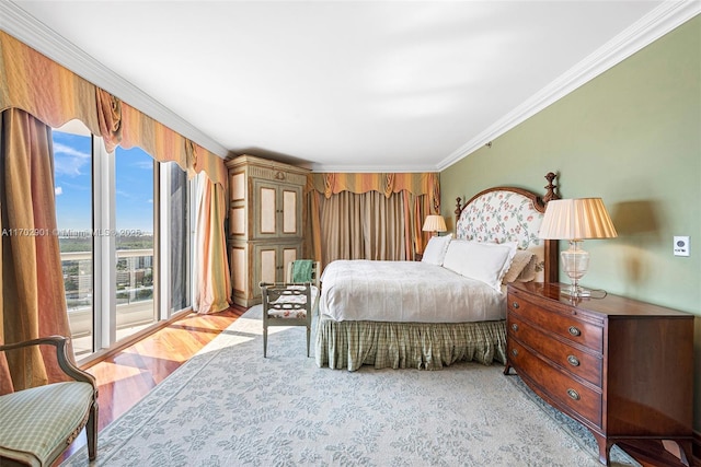 bedroom with light wood finished floors and ornamental molding