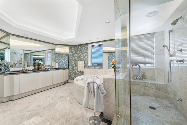 bathroom with vanity, a tray ceiling, and a shower with door