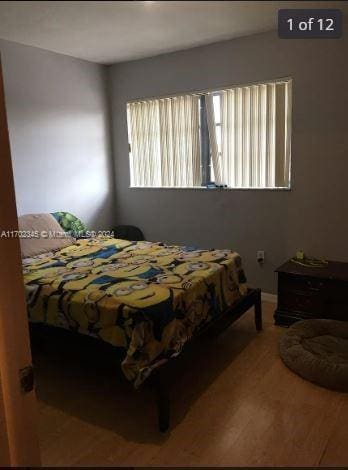 bedroom with wood-type flooring