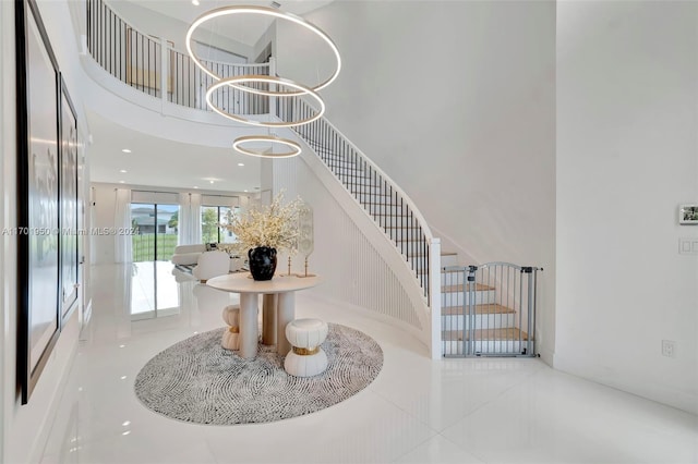 stairway with tile patterned floors and a high ceiling