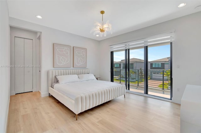 bedroom with access to outside, light hardwood / wood-style flooring, and a notable chandelier