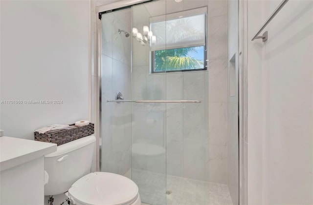 bathroom featuring toilet and an enclosed shower