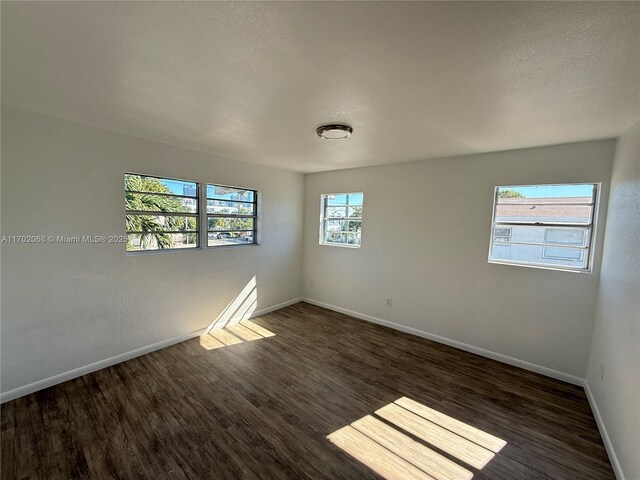 236 SW 10th Ave, Miami, FL 33130 - spare room with dark wood-style flooring and a textured ceiling