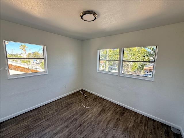unfurnished room featuring dark hardwood / wood-style floors and a healthy amount of sunlight