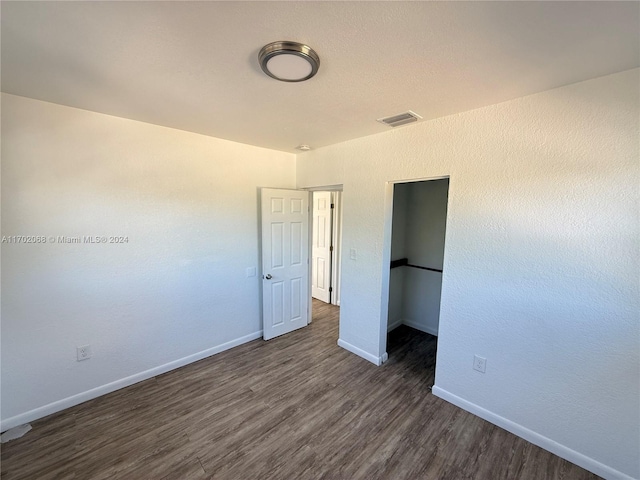 unfurnished bedroom featuring dark hardwood / wood-style floors