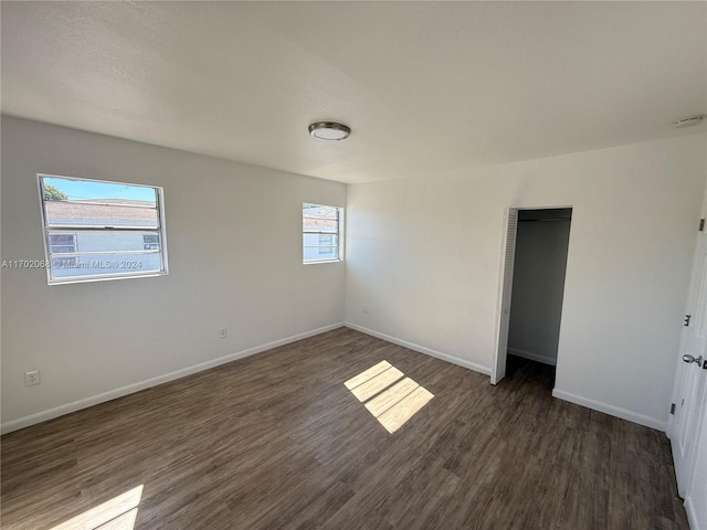 empty room with dark wood-type flooring