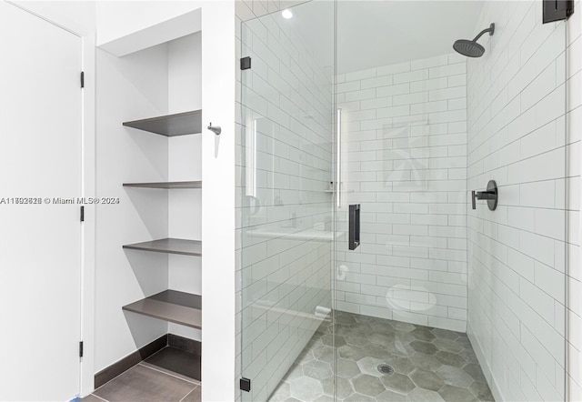 bathroom with a shower with door, tile patterned flooring, and toilet