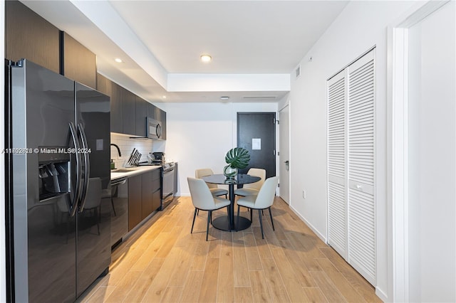 dining area with light hardwood / wood-style flooring and sink