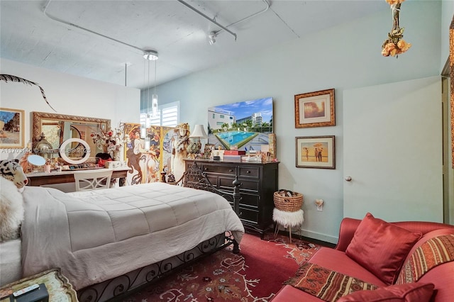 bedroom featuring track lighting