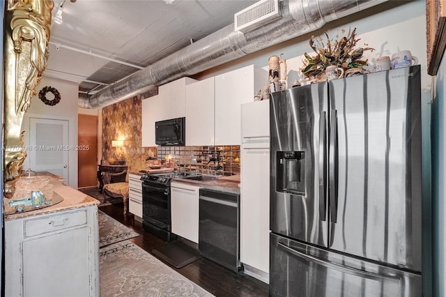 kitchen with white cabinets, dark hardwood / wood-style flooring, tasteful backsplash, and black appliances