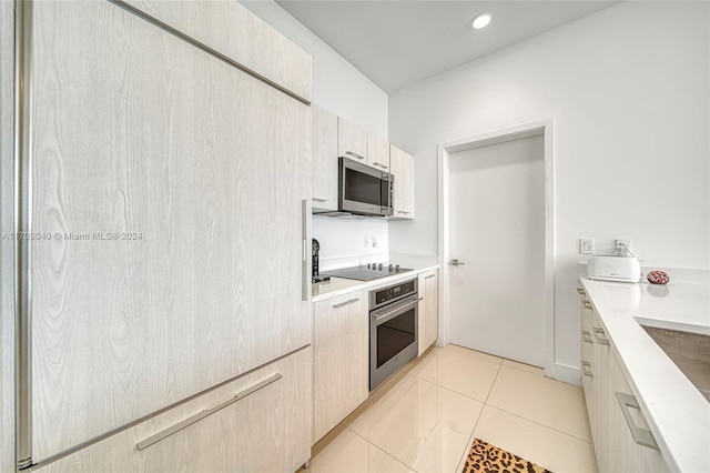 kitchen with light tile patterned floors and stainless steel appliances