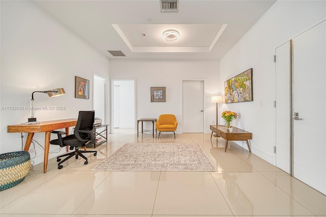 office space featuring a tray ceiling