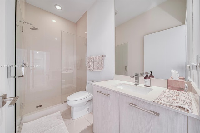 bathroom with tile patterned floors, walk in shower, vanity, and toilet