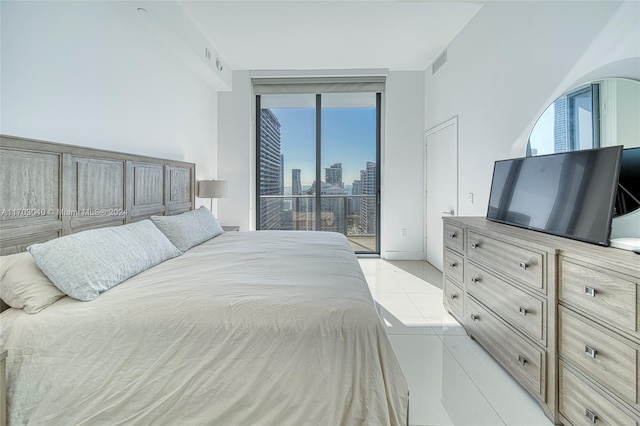 tiled bedroom featuring access to outside and multiple windows